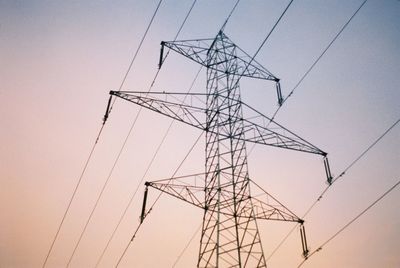 Low angle view of electricity pylon against sky