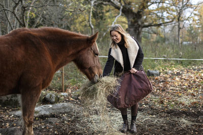 Woman feeding horse