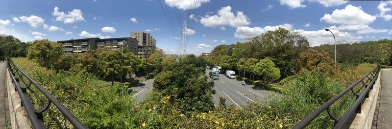 Panoramic view of trees and plants in city against sky