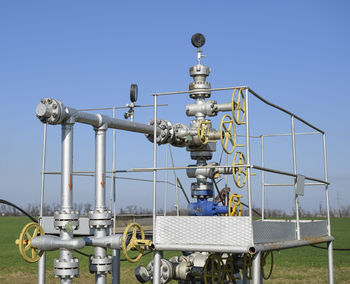 Close-up of coin-operated binoculars against clear blue sky