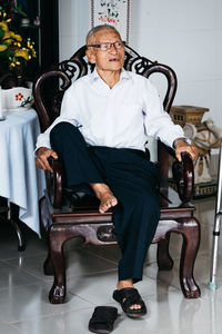 Portrait of man sitting on chair