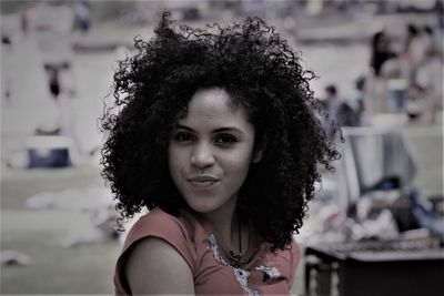 Portrait of smiling afro teenager at public park