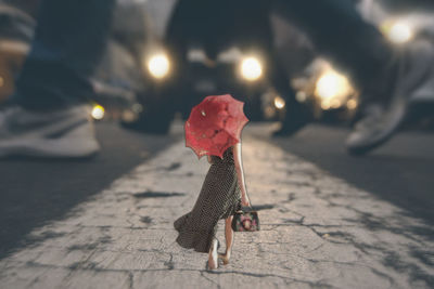 Close-up of umbrella on road