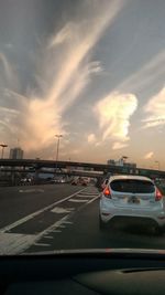 Cars on road at sunset