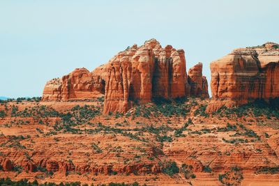 View of rock formations on landscape against clear sky