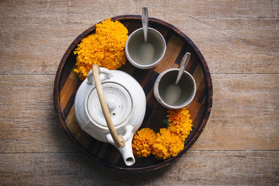 Directly above shot of tea bowl on wooden serving tray