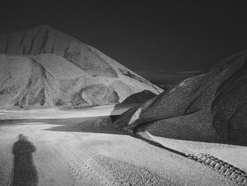 Sand dune in desert against sky