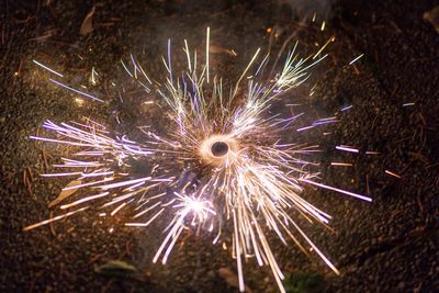 High angle view of firework display at night
