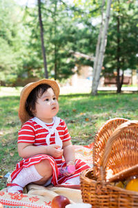 Cute boy sitting in basket