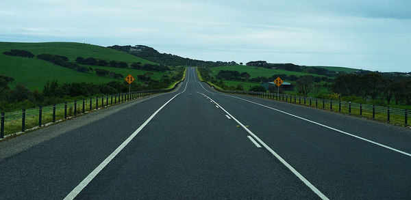 Empty road along countryside landscape