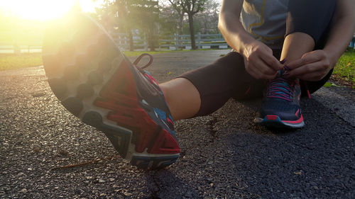Low section of man sitting on road