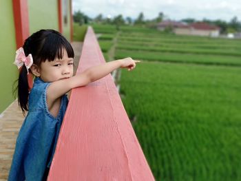 Full length of cute girl playing on field