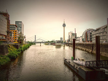 Bridge over river with buildings in background