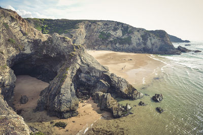 High angle view of rocks on beach against sky