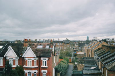 Buildings against cloudy sky