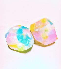 Close-up of multi colored candies against white background