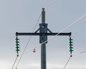 Low angle view of communications tower against sky