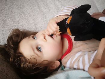 Portrait of baby boy lying on bed at home