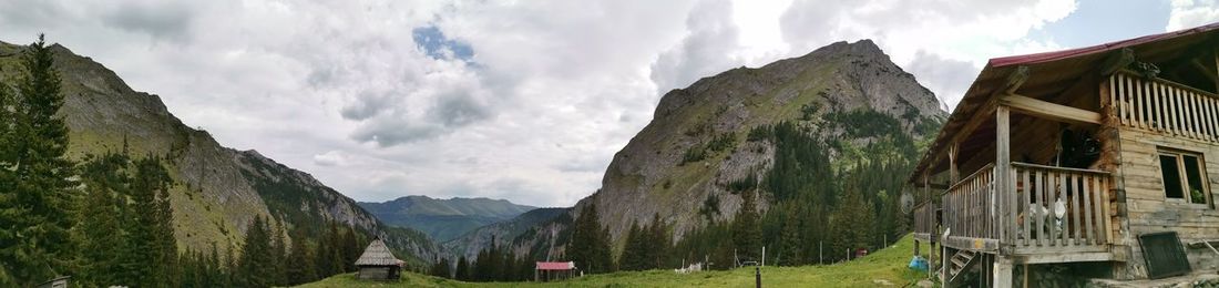 Panoramic view of trees and houses against sky in retezat mountain