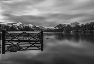 Gazebo by lake against sky