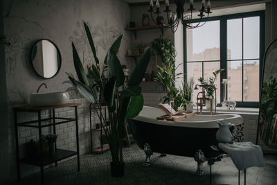 Luxury interior of big bathroom at modern african style with oval bathtub in natural lighting