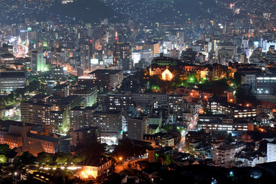 High angle view of illuminated city buildings at night