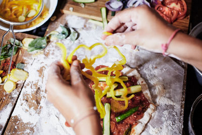 Close-up of hand holding food on table