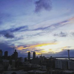 Skyscrapers in city at sunset