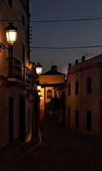 Illuminated city against sky at dusk