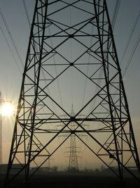 Low angle view of electricity pylon against sky