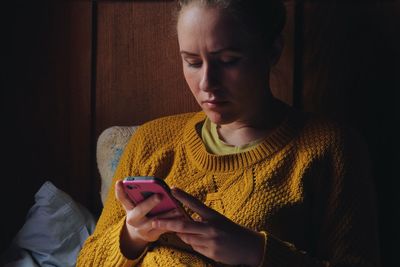 Midsection of man using mobile phone