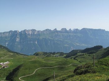 Scenic view of green landscape against mountains