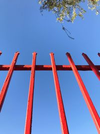 Low angle view of crane against clear blue sky