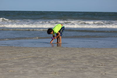 Full length of man on beach against sky