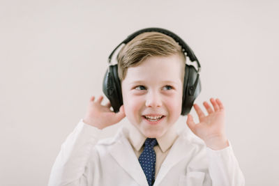 Child in labcoat with headphones