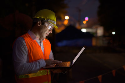 Man working on laptop at night