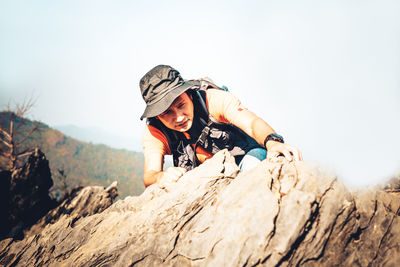 Full length of woman on rock against sky