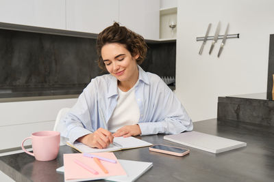 Portrait of young businesswoman working at office