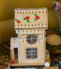 Close-up of cake house on table