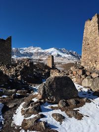 Snow covered mountain against clear blue sky