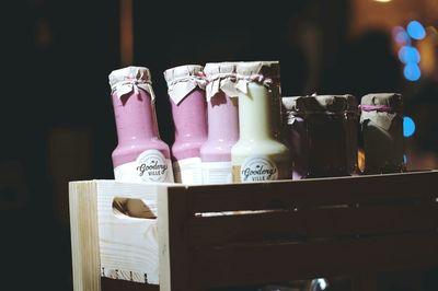 Close-up of bottles in wooden container