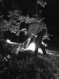 Man standing on field against trees