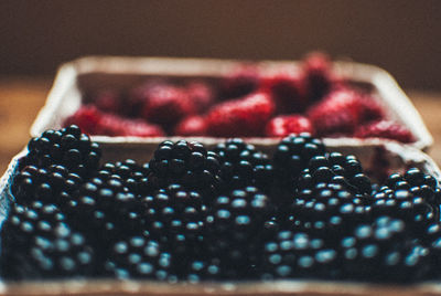 Close-up of blackberries and raspberries in containers