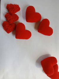 High angle view of red heart shape on white table