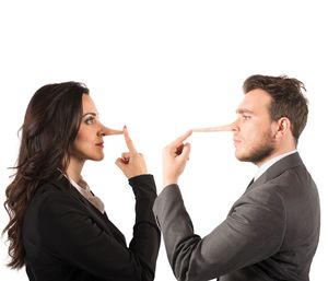 Young couple kissing against white background