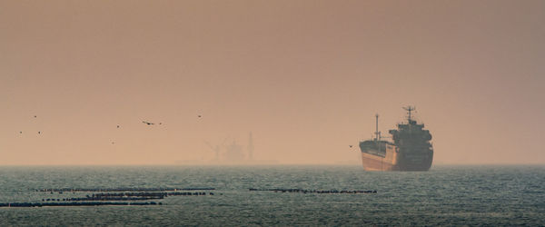 Scenic view of sea against clear sky during sunset