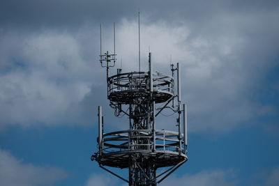 Low angle view of electricity pylon against sky