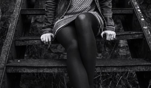 Close-up of woman sitting on steps