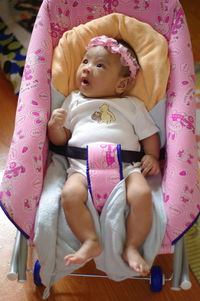Cute baby girl lying on bed