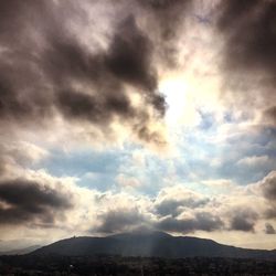 Scenic view of mountains against cloudy sky